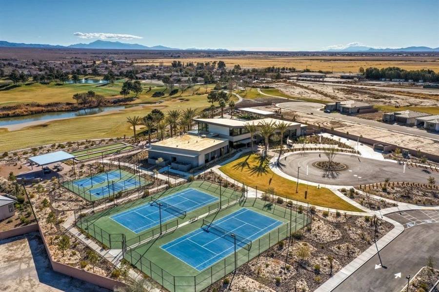 Aerial view of tennis and pickleball courts next to the community clubhouse