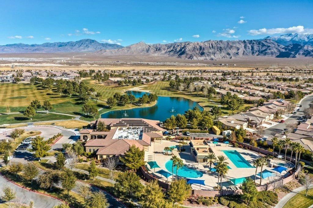 Aerial view of the Mountain Falls clubhouse, resort pool complex and golf course, with mountains behind